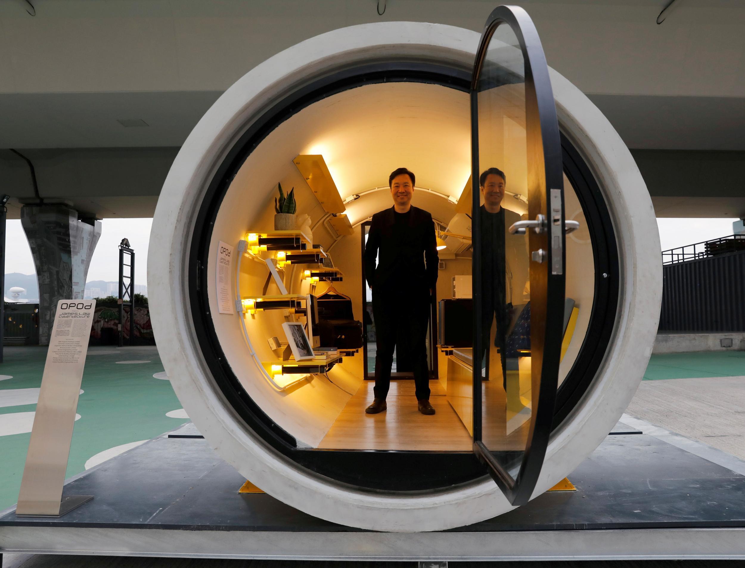 Architect James Law stands in his ‘OPod’: a 120-square-foot giant water pipe designed as micro-housing in Hong Kong