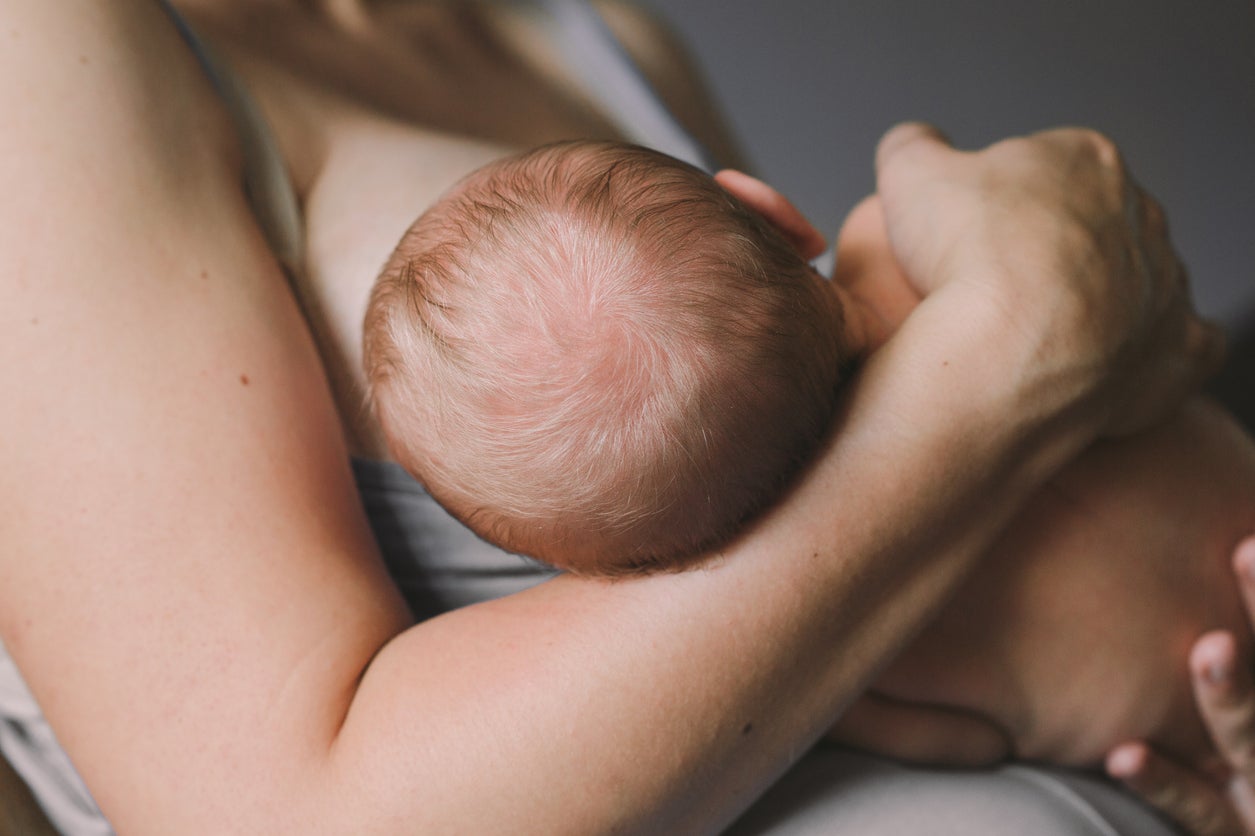 A mother has been praised for sharing a photo of herself breastfeeding her baby during an ice hockey match