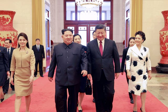 Ri Sol-ju with her husband, Kim Jong-un, as they walk with China's president, Xi Jinping, and his wife, Peng Liyuan