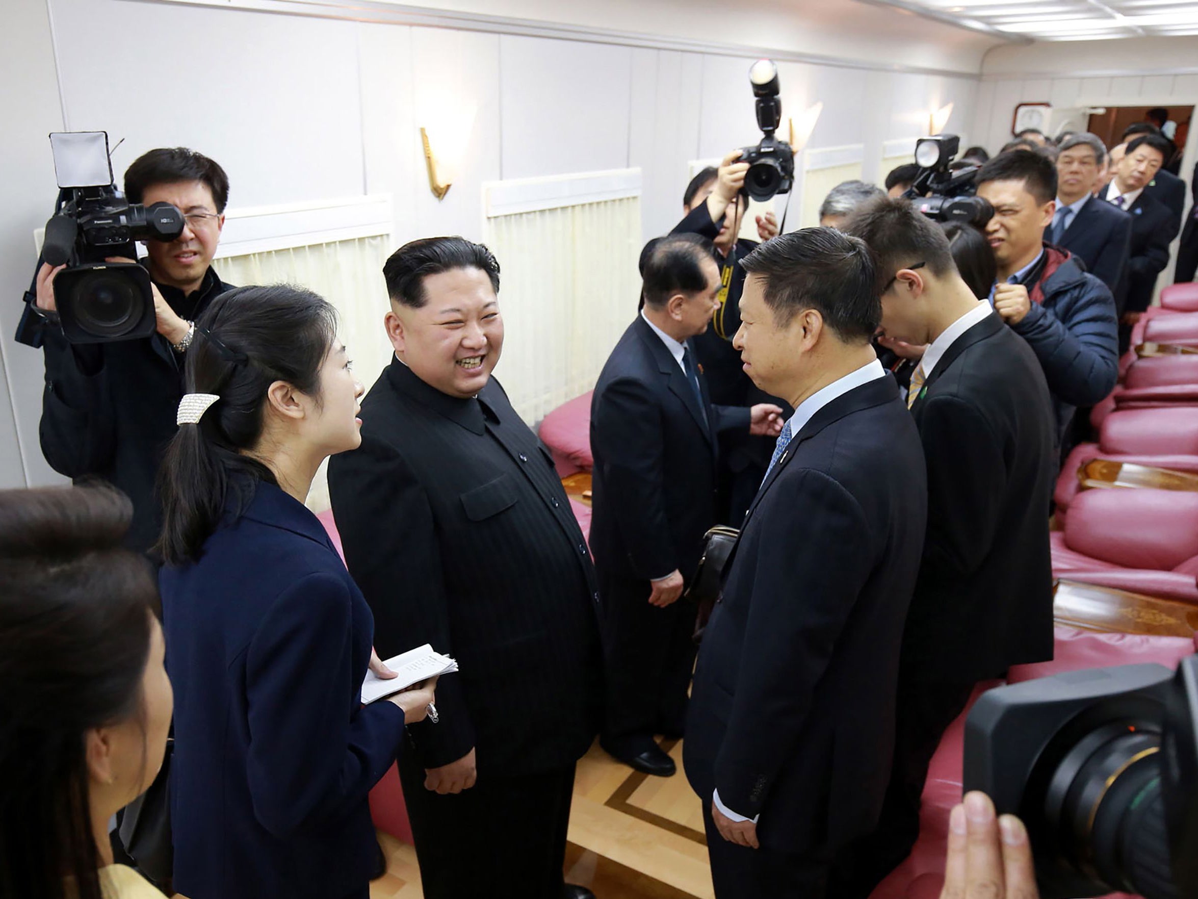 Kim Jong-un meets Chinese officials aboard his train in this photo released by North Korea's state news agency