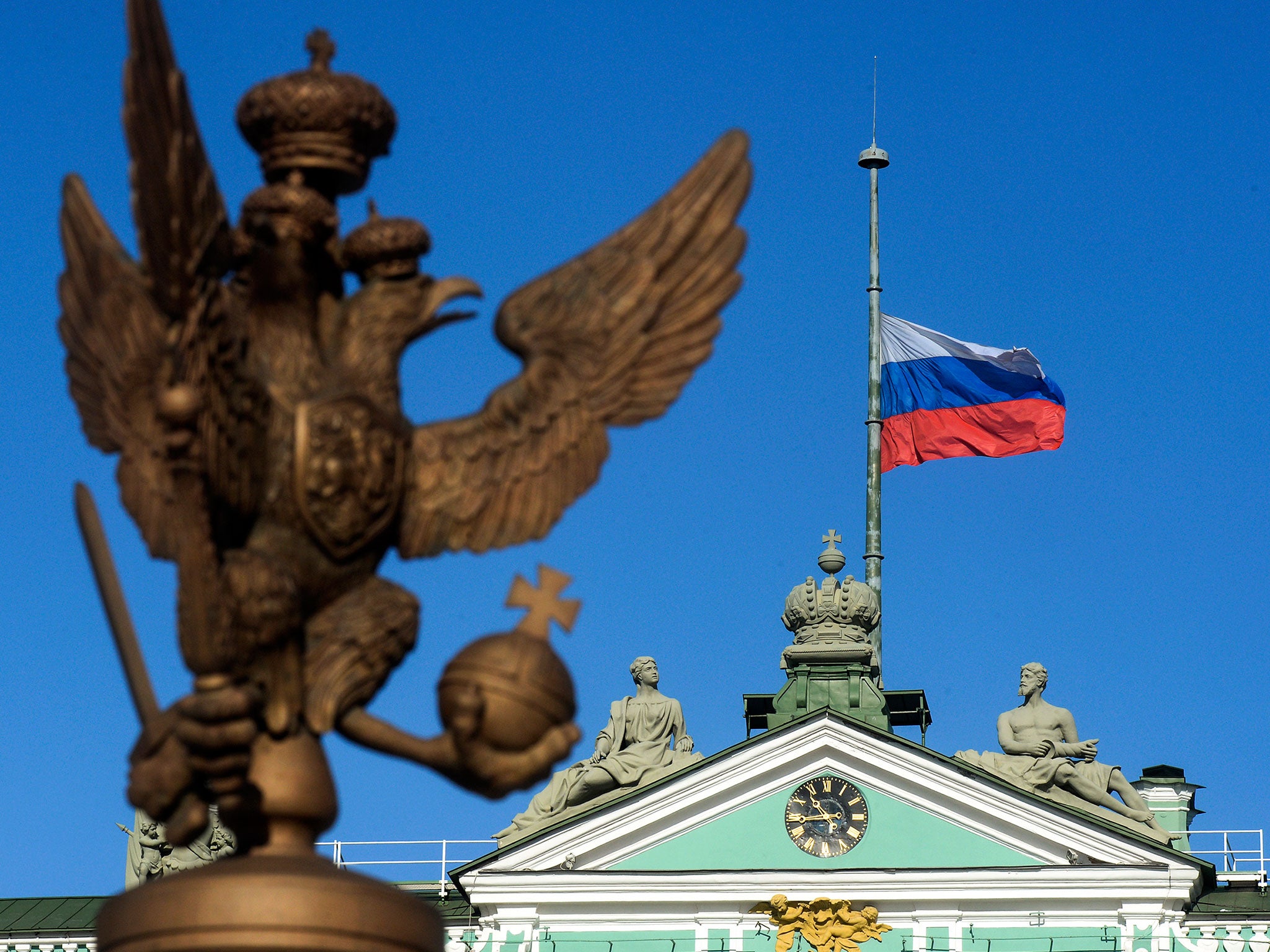 The Russian flag flies at half-mast over the State Hermitage Museum on Dvortsovaya Square in Saint Petersburg