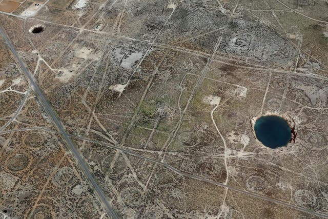 Two massive sinkholes near the town of Wink, Texas, have been linked to past fossil fuel extraction in the region
