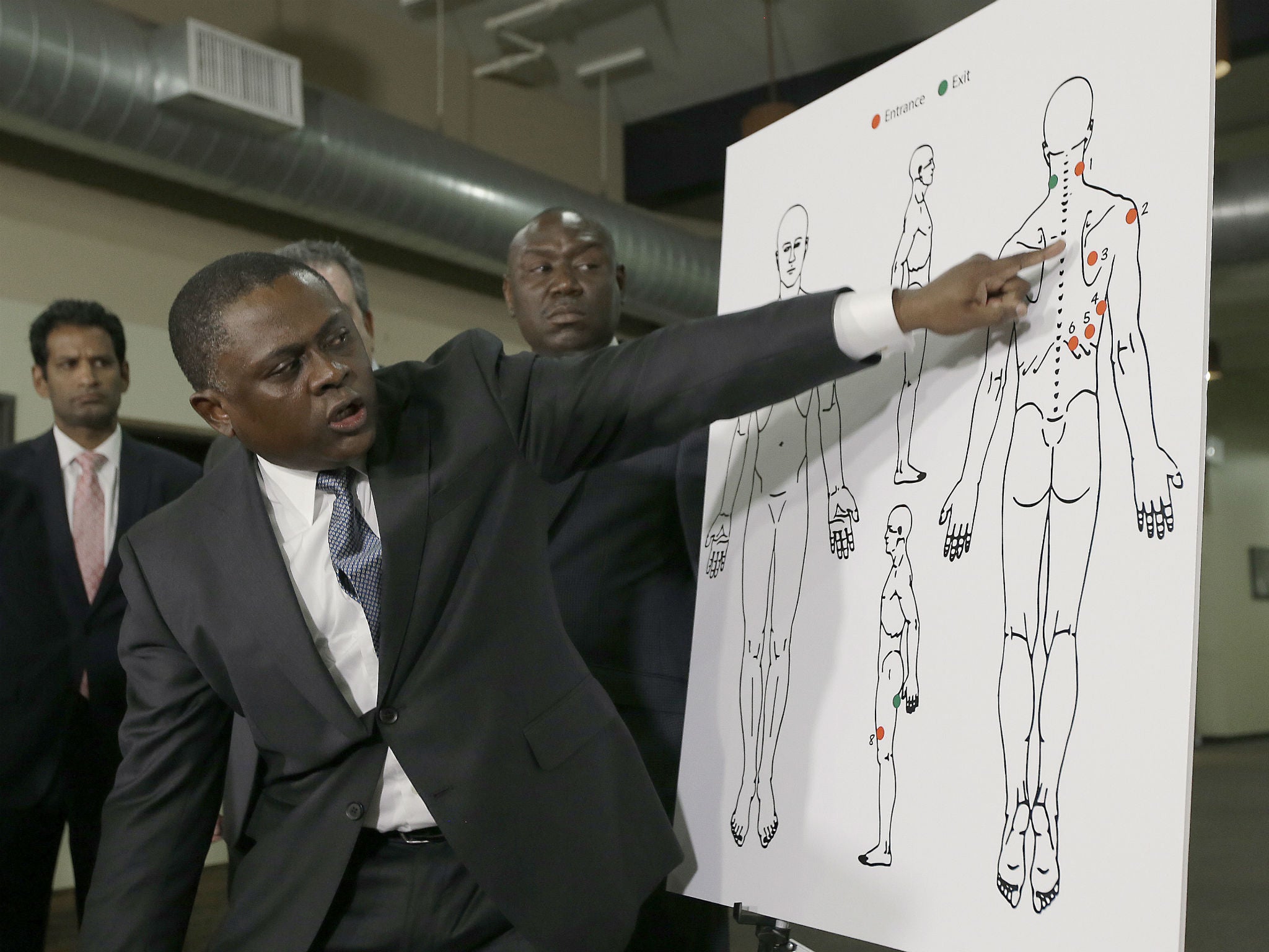 Dr Bennet Omalu gestures to a diagram showing where police shooting victim Stephon Clark was struck by bullets