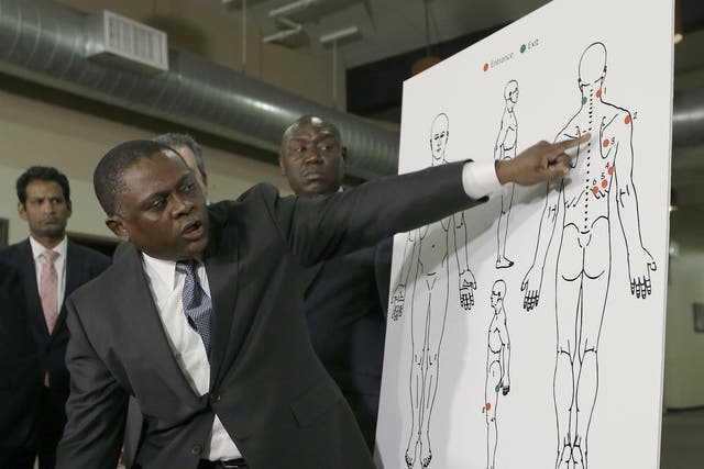 Dr Bennet Omalu gestures to a diagram showing where police shooting victim Stephon Clark was struck by bullets