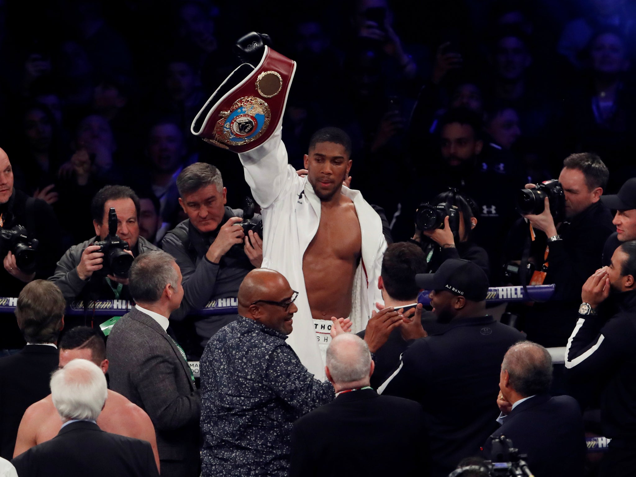 Anthony Joshua celebrates adding the WBO heavyweight title to his IBF and WBA championships