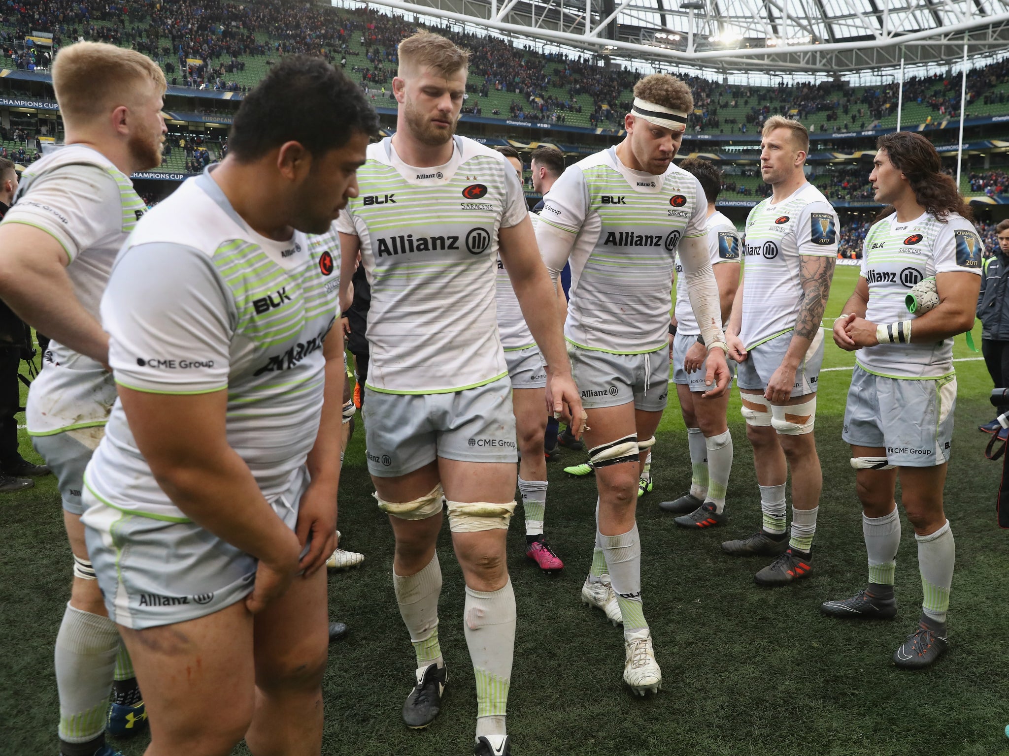 Saracens players leave the field dejected after the defeat by Leinster