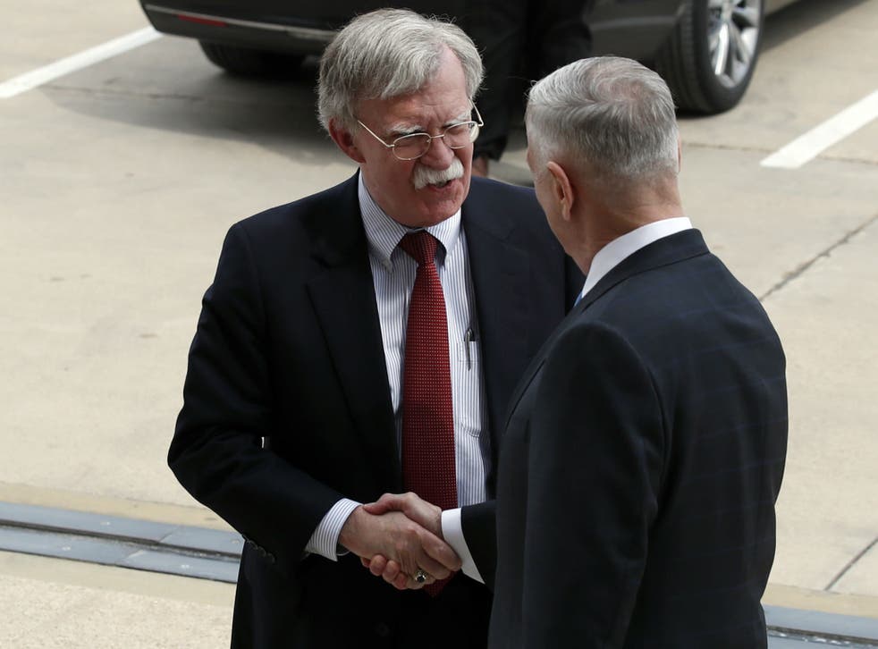 John Bolton shakes hands with Defense Secretary Jim Mattis as Bolton arrives at the Pentagon