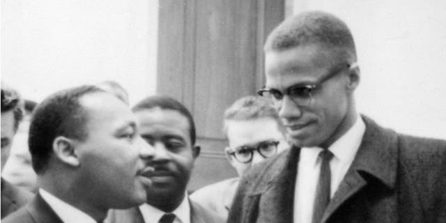 <p>Martin Luther King, Jr, speaks with Malcom X </p>