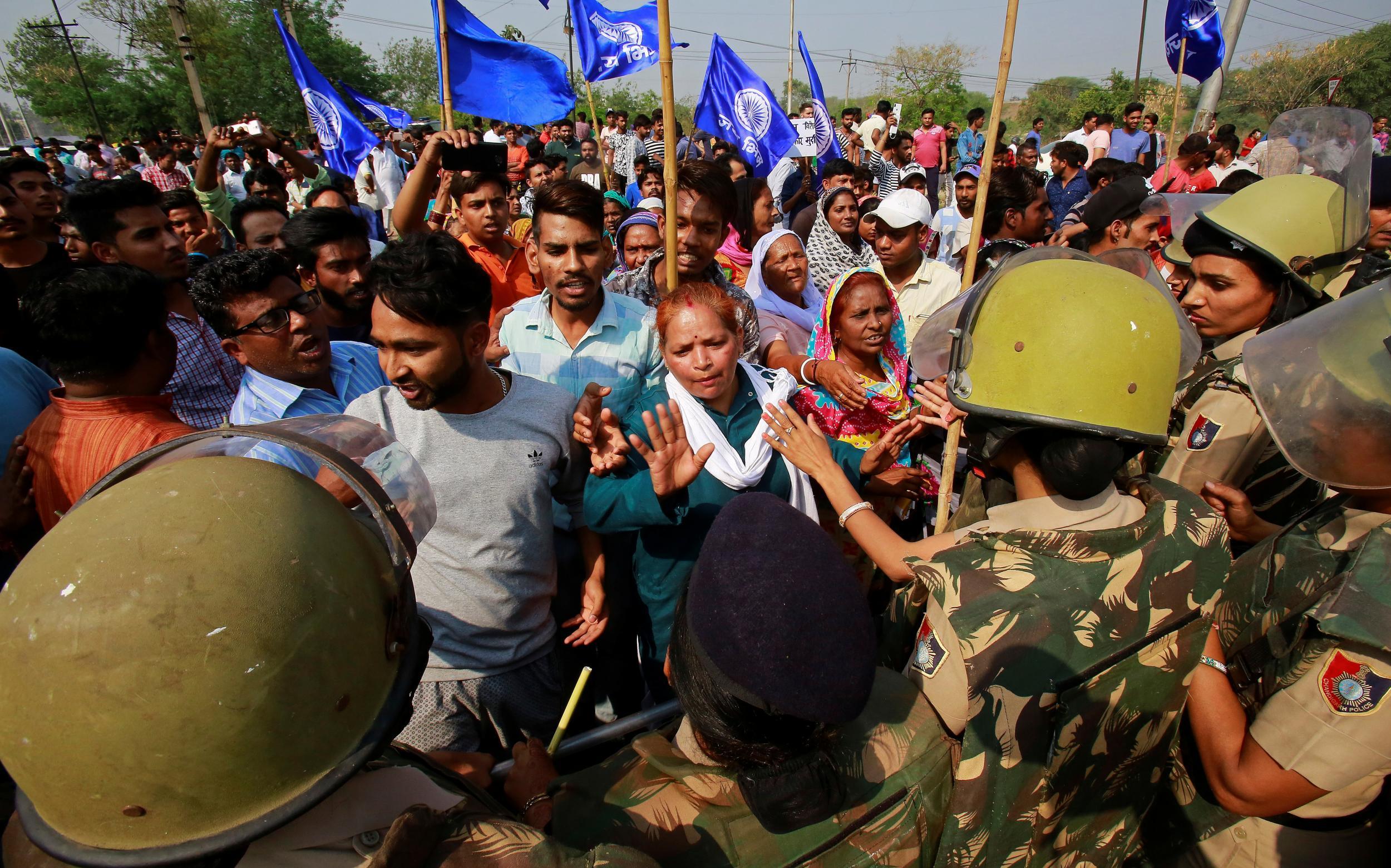 Police try to stop members of the Dalit community during a nationwide strike