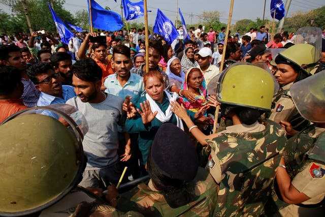 Police try to stop members of the Dalit community during a nationwide strike
