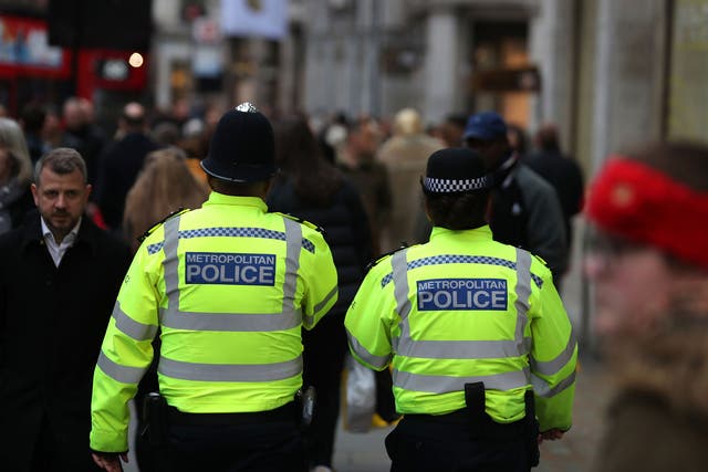 Members of the Metropolitan Police patrol amongst the shoppers on Oxford Street, in central London on December 21, 2017