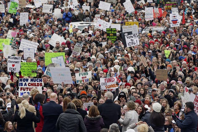 The crowd cheers during a teacher rally at the state Capitol in Oklahoma City on 2 April 2018. Teachers were holding separate protests in Oklahoma and Kentucky on Monday to voice dissatisfaction with issues like pay and pensions.