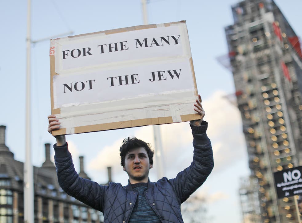 A demonstrator calls for action over antisemitism in Westminster in March last year 