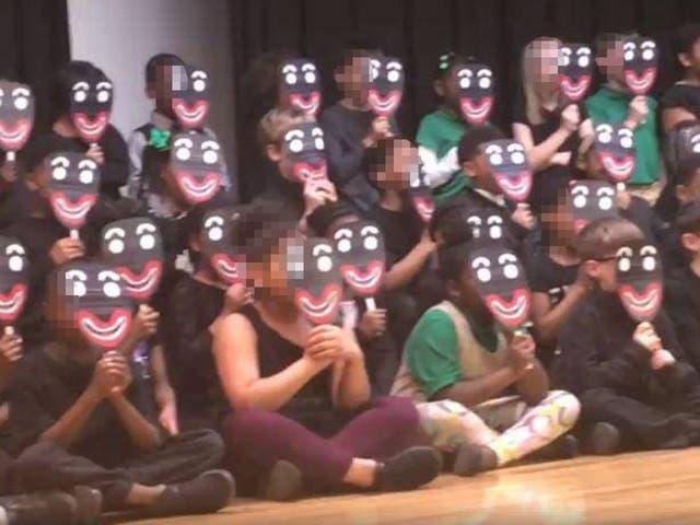 Pupils at Kindezi Old Fourth Ward Charter School perform in blackface masks