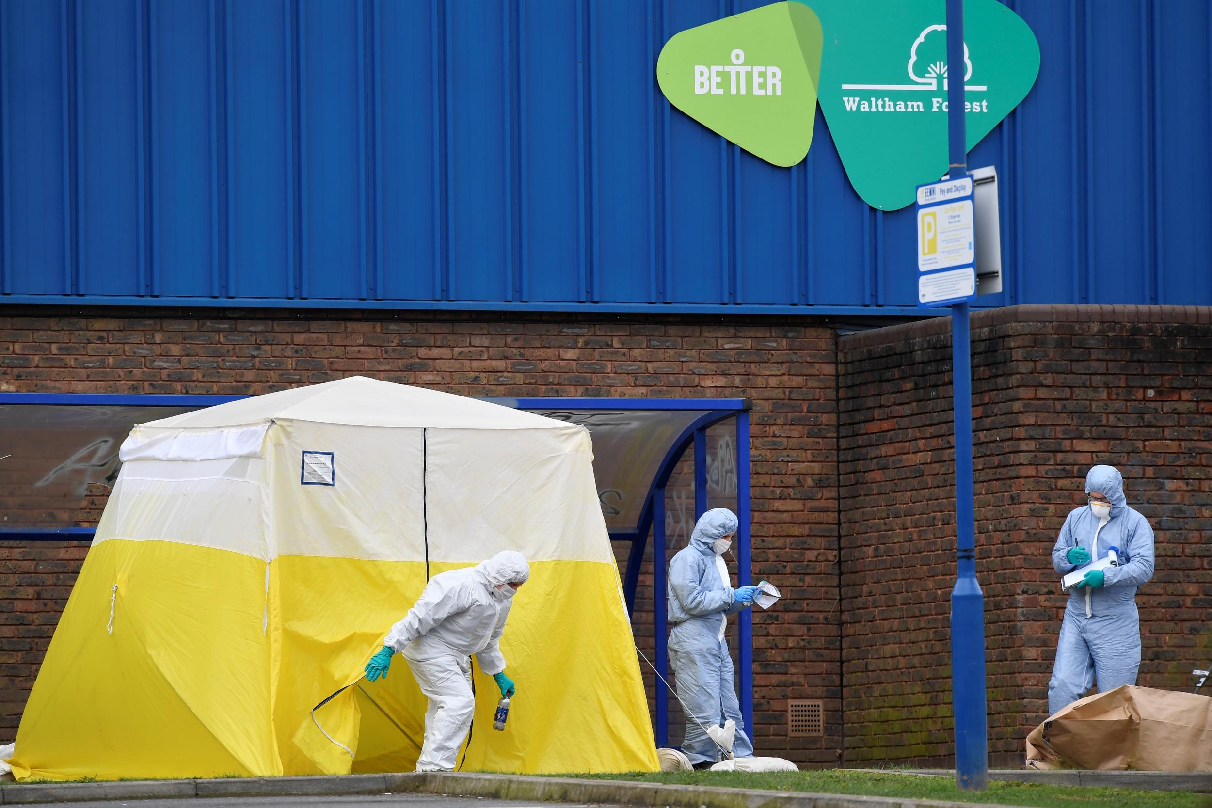 Forensic investigators examine the scene around Walthamstow Leisure Centre, where a 16-year-old boy was fatally shot