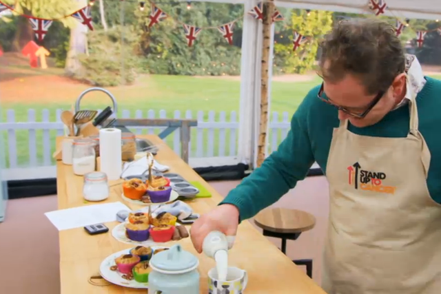 Alan Carr pours milk into a mug of tea on The Great Celebrity Bake Off for SU2C