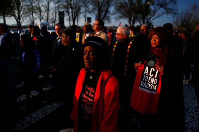 People attend a silent march and rally on the National Mall to mark the 50th anniversary