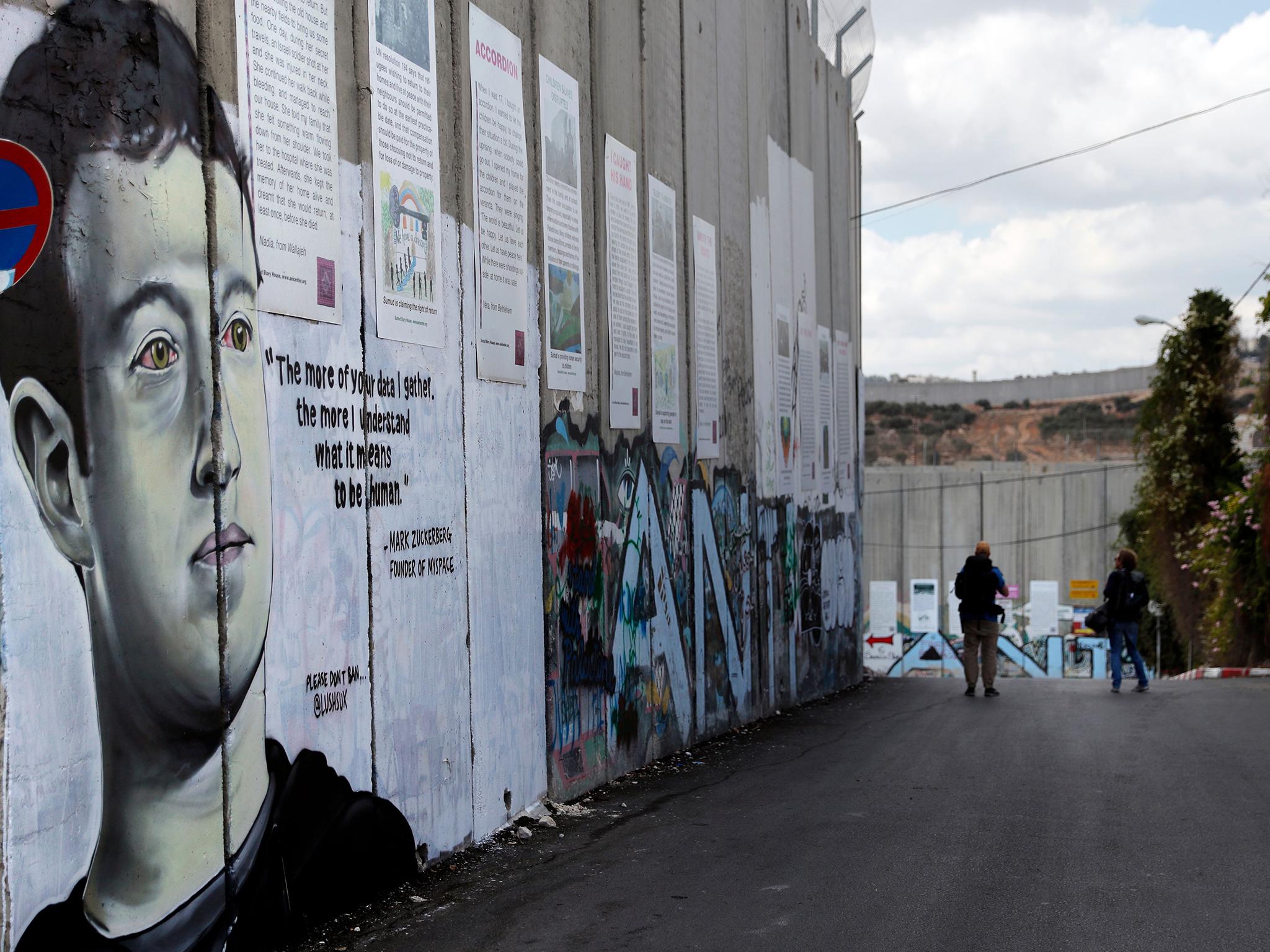 Graffiti depicting Facebook CEO Mark Zuckerberg on the separation barrier between the West Bank town of Bethlehem, and Jerusalem