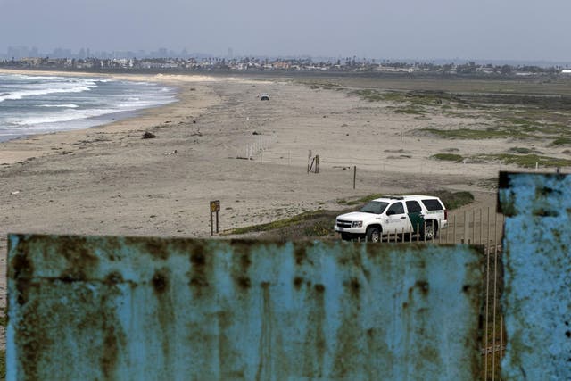 A US border patrol keeps watch on US soil across the US-Mexico border fence, as seen from Playas de Tijuana in northwestern Mexico