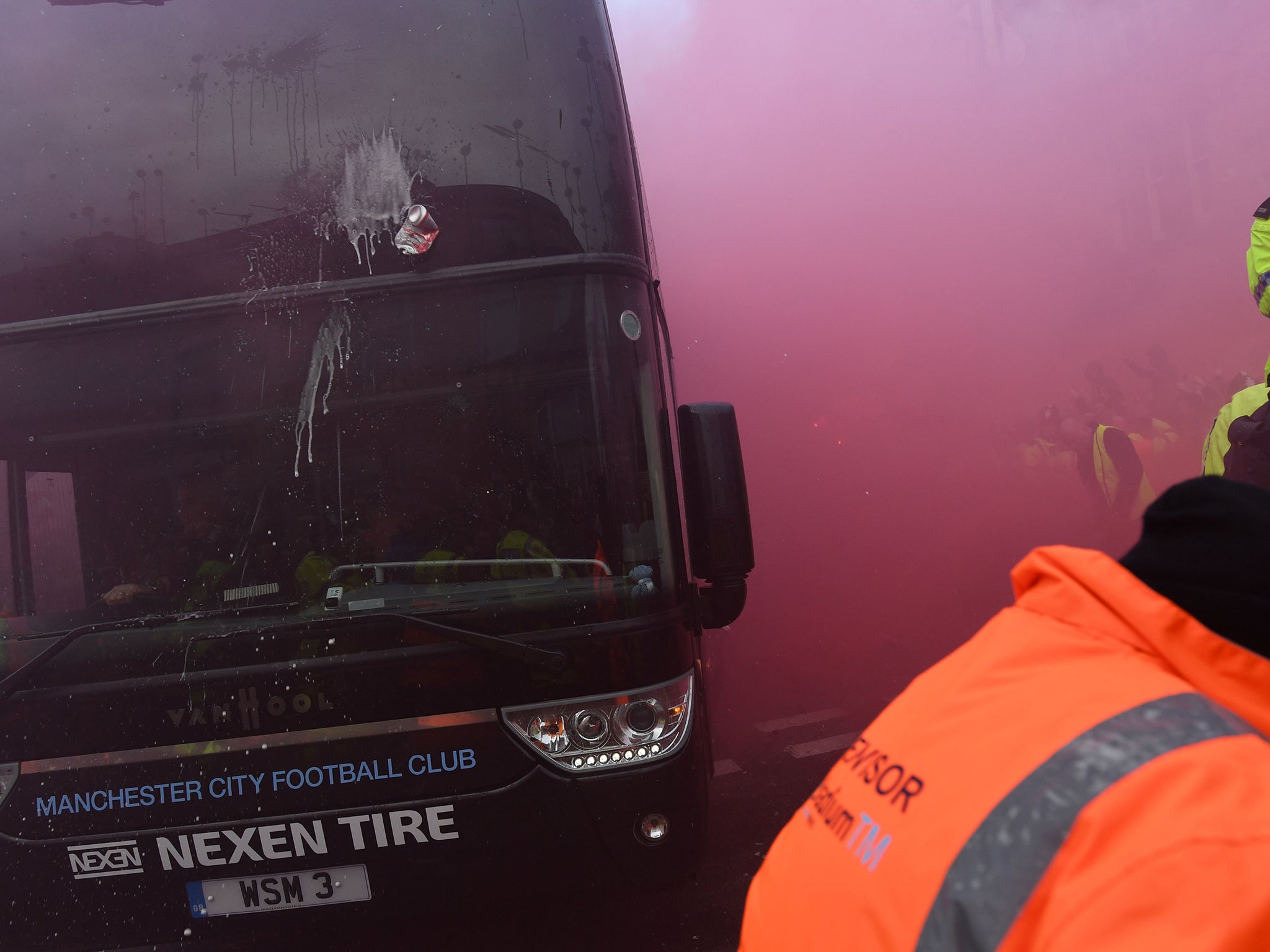 Thirteen coach windows were smashed as Liverpool fans threw bottles and cans at the Manchester City bus