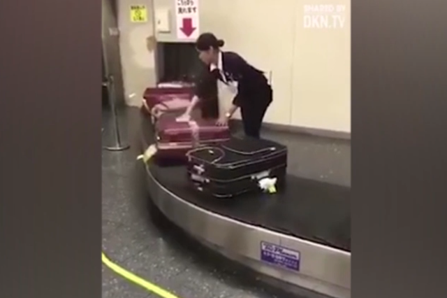 This Japanese airport worker was filmed cleaning bags