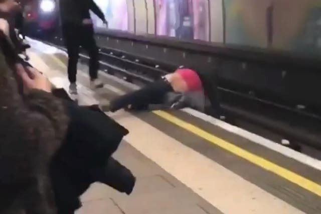 Witnesses said the men appeared to be drunk and were wrestling near the edge of the platform