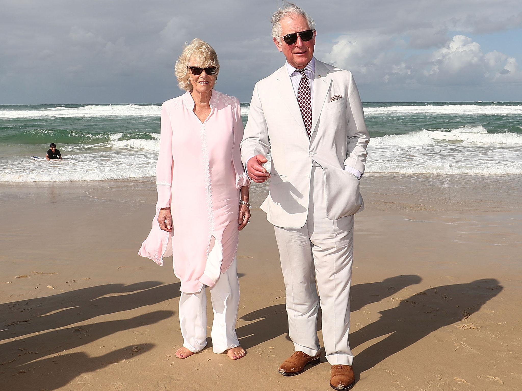 Prince Charles and Camilla, Duchess of Cornwall, walk on Broadbeach in Gold Coast, Australia, during their seven-day tour