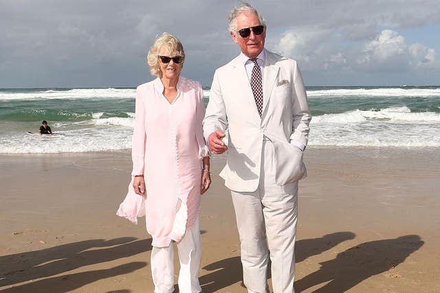 Prince Charles and Camilla, Duchess of Cornwall, walk on Broadbeach in Gold Coast, Australia, during their seven-day tour