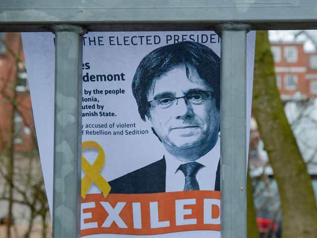 A picture of forner Catalan leader Carles Puigdemont attached to the fence of the prison in Neumuenster, northern Germany, where he was detained