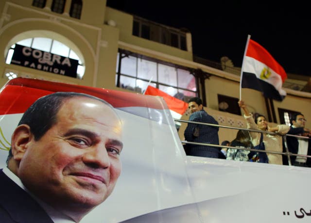 Supporters of Egyptian President Abdel Fattah al-Sisi celebrate in Heliopolis after the presidential election results were announced