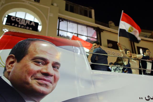 Supporters of Egyptian President Abdel Fattah al-Sisi celebrate in Heliopolis after the presidential election results were announced