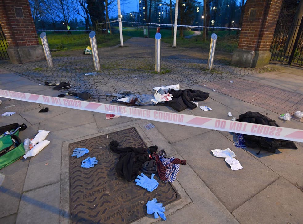 Bloodied clothes on the ground near the scene of a stabbing in Mile End