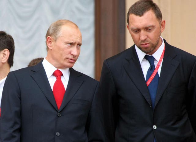 Vladimir Putin speaks with Oleg Deripaska