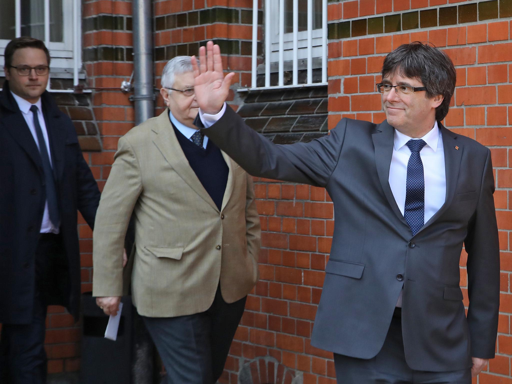 Carles Puigdemont and political colleagues give the thumbs-up after last year's referendum