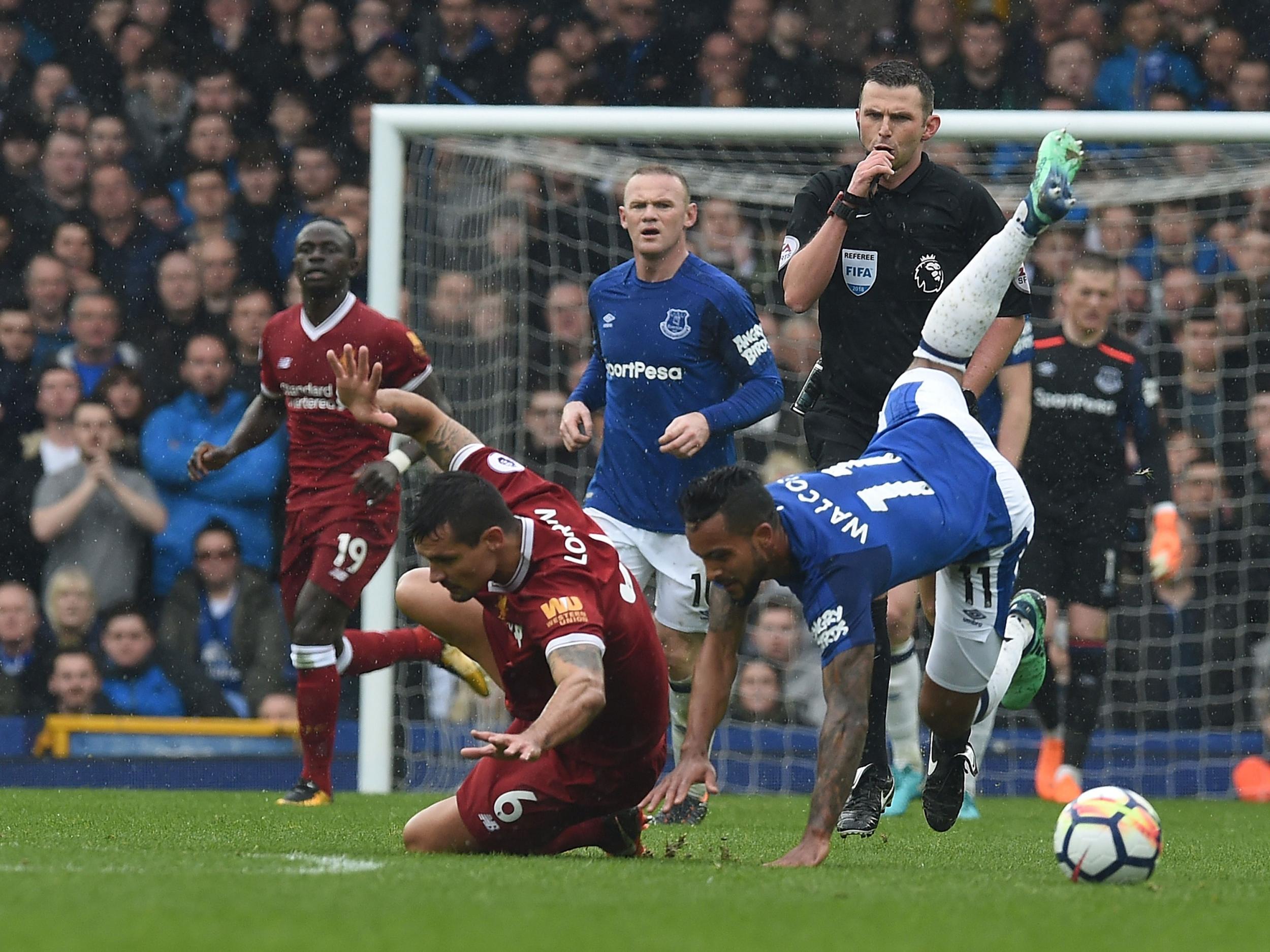 Dejan Lovren brings down Theo Walcott