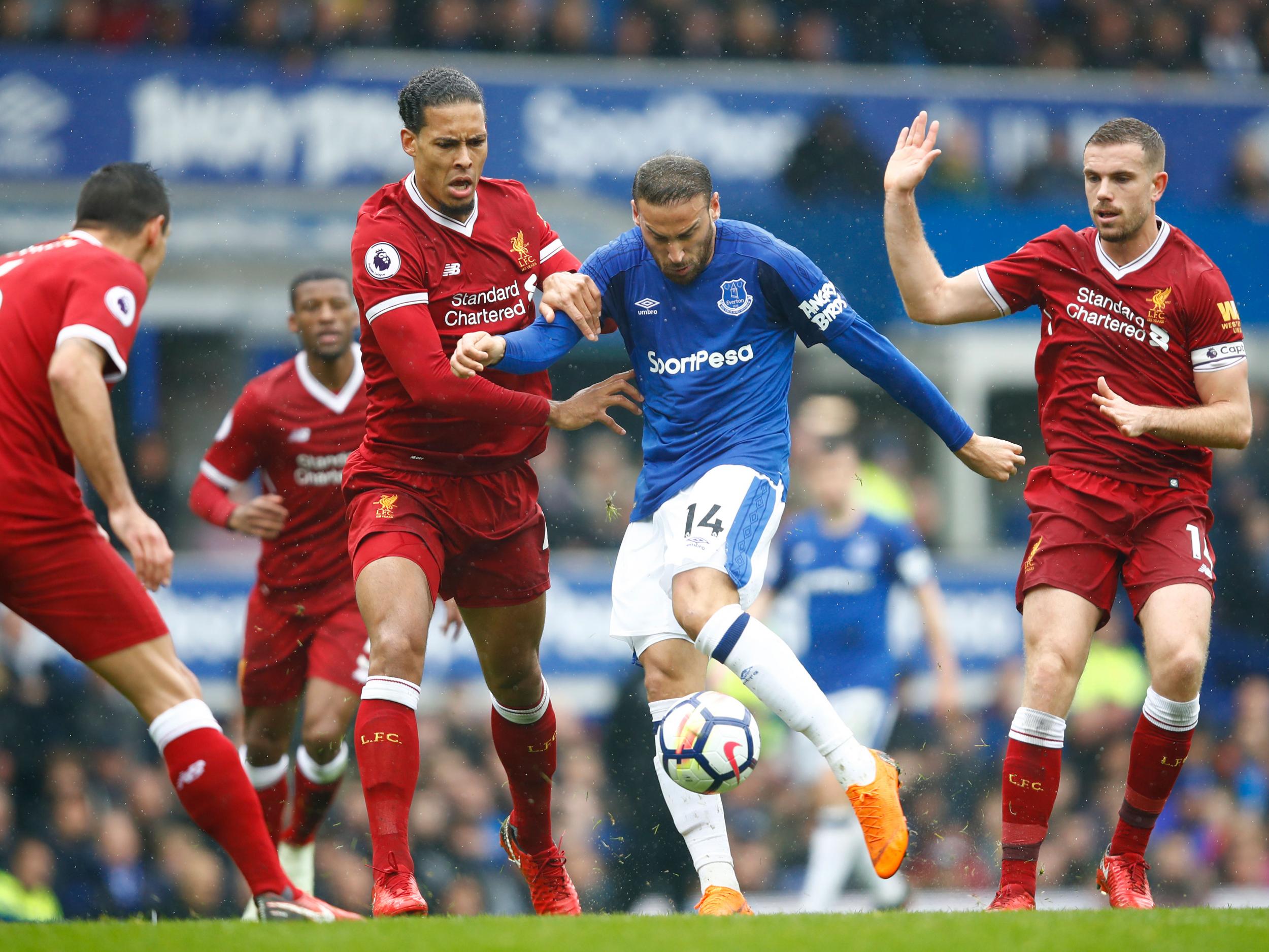 Cenk Tosun is swarmed by a group of red shirts