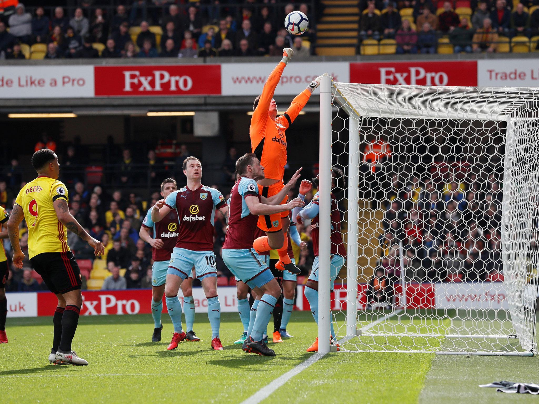 Tom Heaton punches clear a Watford cross