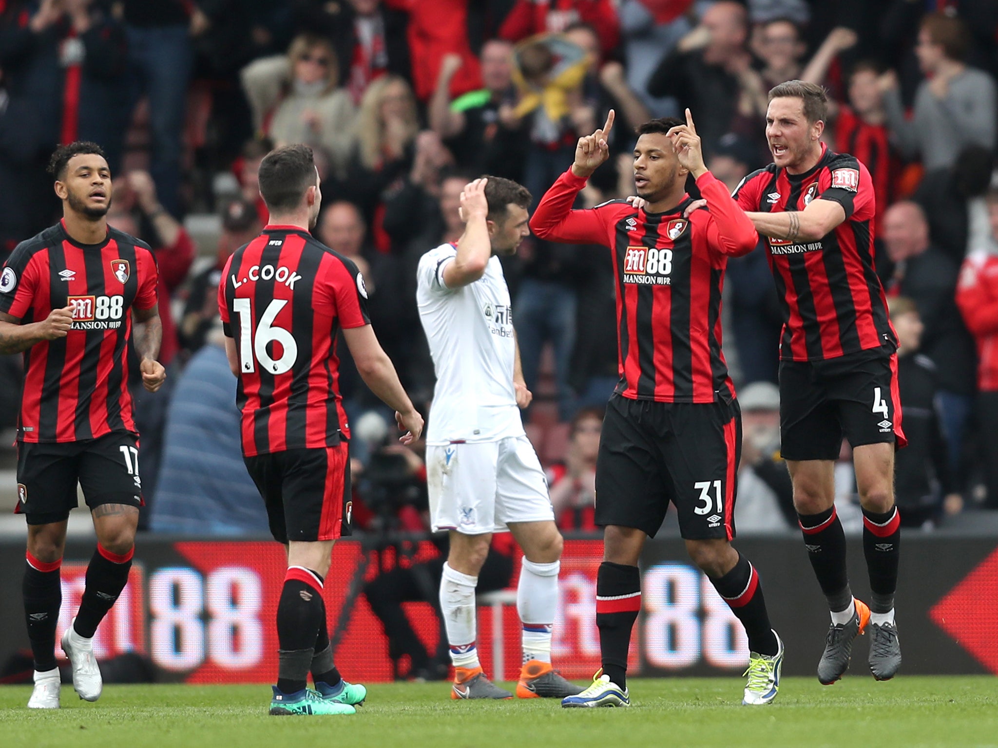 Dan Gosling celebrates with his teammates after getting Bournemouth back on level terms