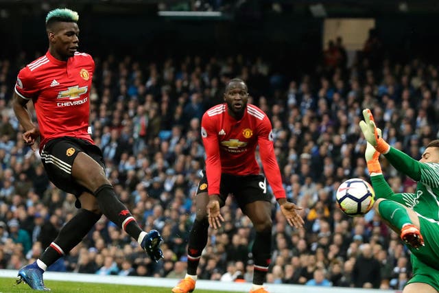 Paul Pogba scores the first of two goals for Manchester United against rivals City