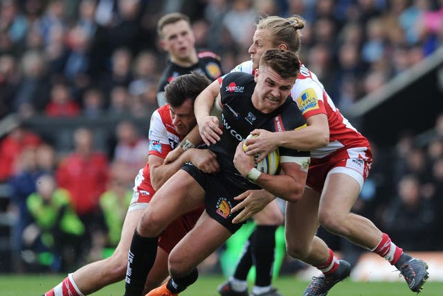 Henry Slade is tackled in midfield