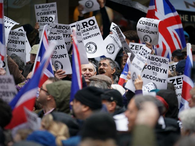 Protesters from the Campaign Against Antisemitism demonstrate and listen to speakers outside the Labour Party headquarters on 8 April