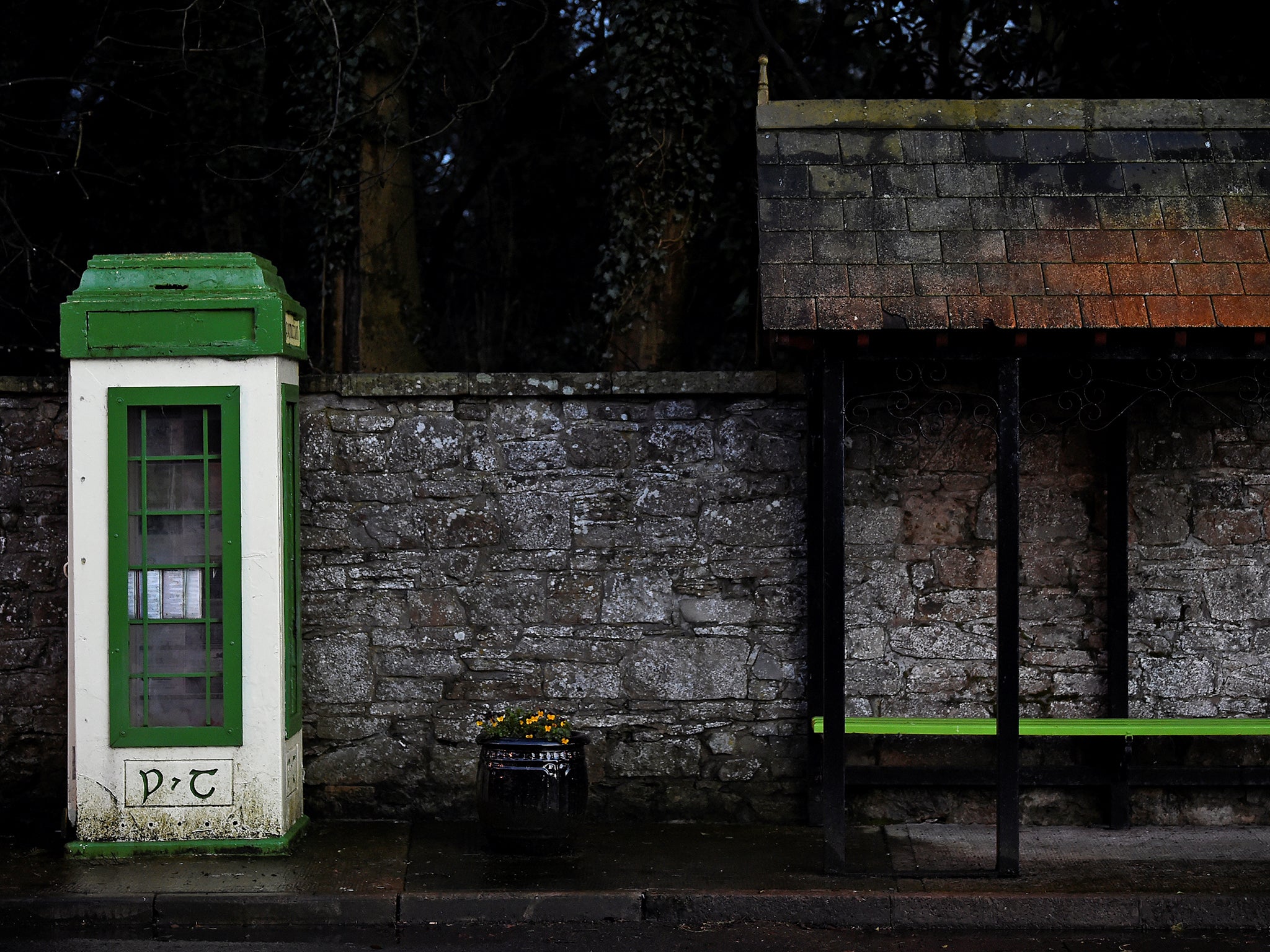 &#13;
An old Irish phone box stands alongside a bus stop in the border town of Glaslough, Co Monaghan &#13;