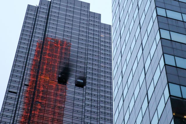 Damaged windows at Trump Tower after a fore broke out in a 50th floor apartment