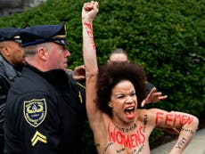 Topless protester arrested after charging at Bill Cosby outside court