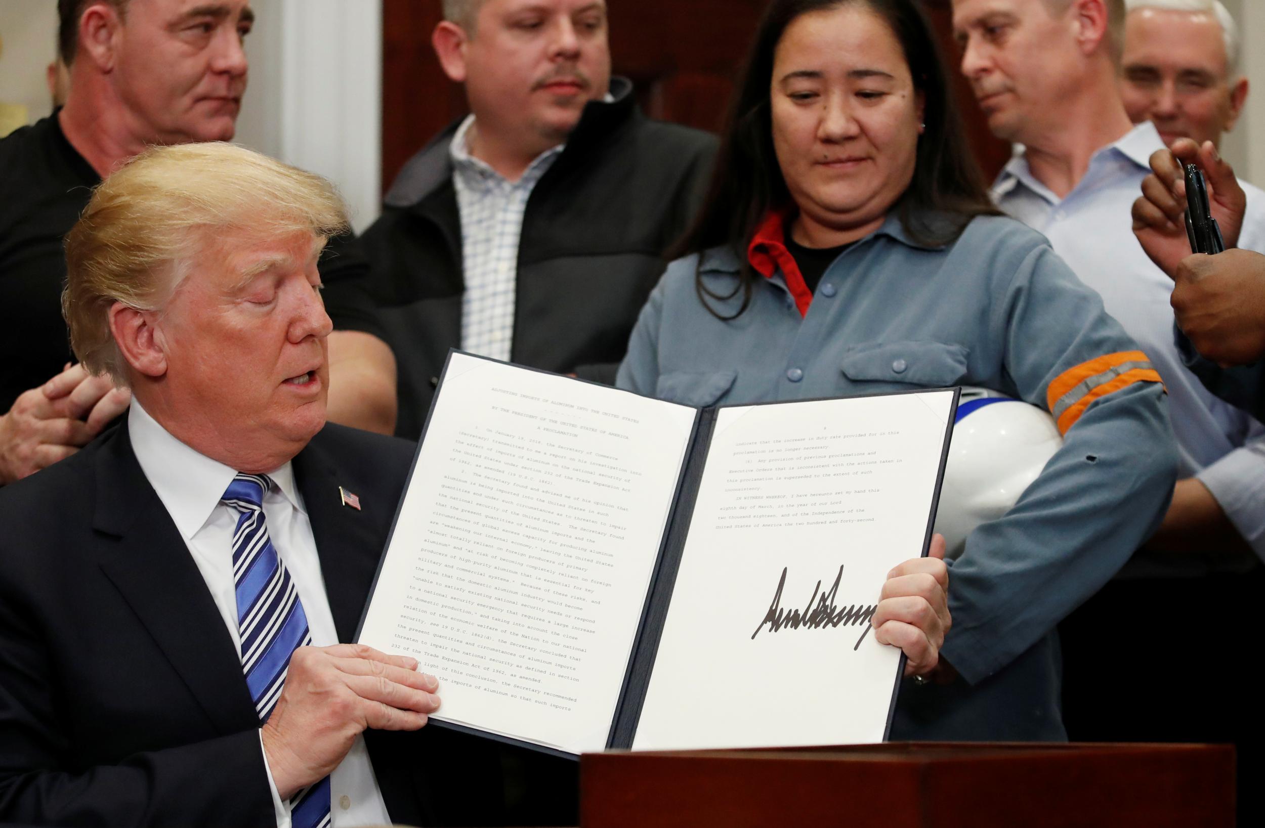 Trump signs a presidential proclamation placing tariffs on steel and aluminum imports