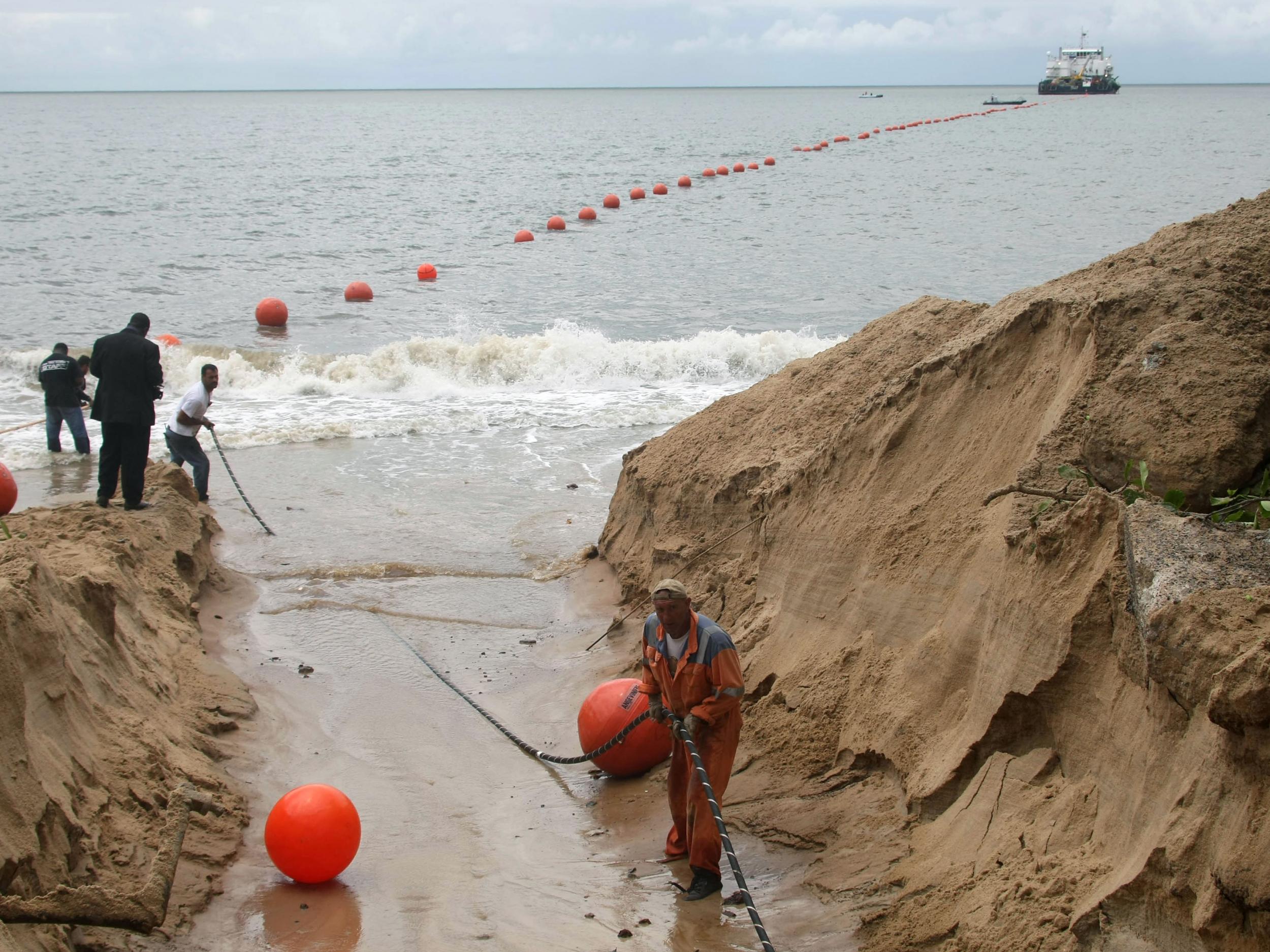 Technicians working on the installation of the ACE submarine fiber optic cable on the shores of Libreville, Gabon, in October 2011