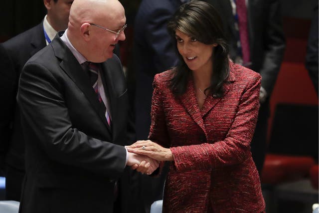 Russian ambassador to the United Nations Vasily Nebenzya, left, and US Ambassador to the UN Nikki Haley shake hands before the Security Council meeting