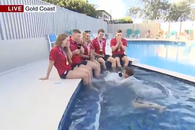 Mike Bushell fell into a swimming pool while attempting to interview members of Team England