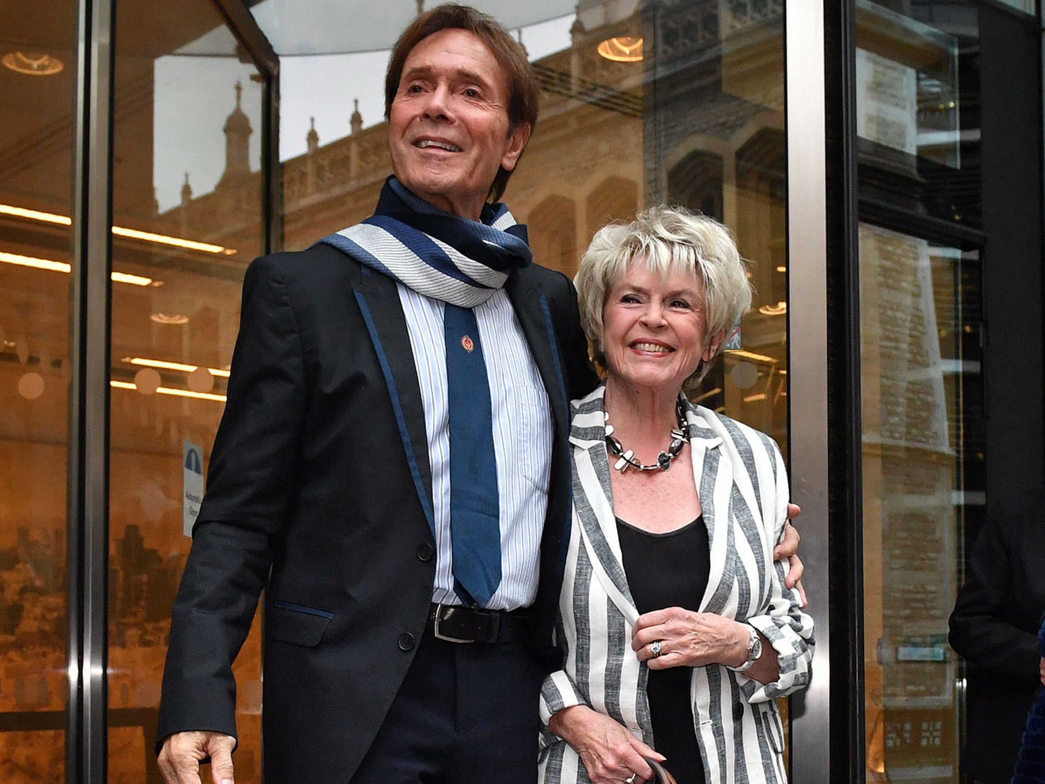 Sir Cliff Richard leaves the Rolls Building in London with Gloria Hunniford, where he gave evidence in a legal battle against the BBC