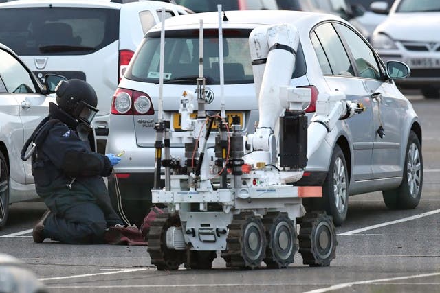 A member of the RAF bomb disposal unit investigates a Volkswagen Golf parked at HMP Peterborough